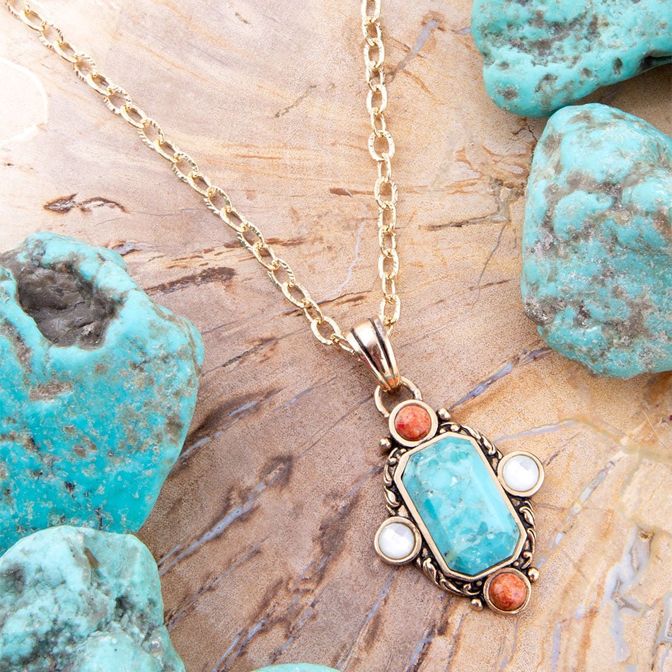 Barse Jewelry earrings featuring blue turquoise, orange coral, and gold accents with a pendant design.