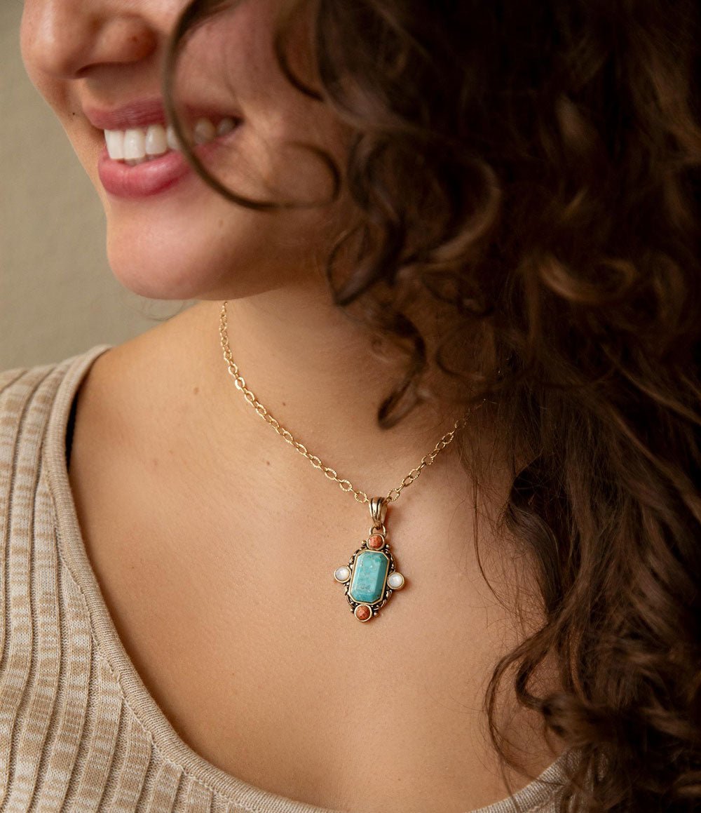 Barse Jewelry earrings featuring blue turquoise and orange coral design with golden accents in a stylish pendant style.