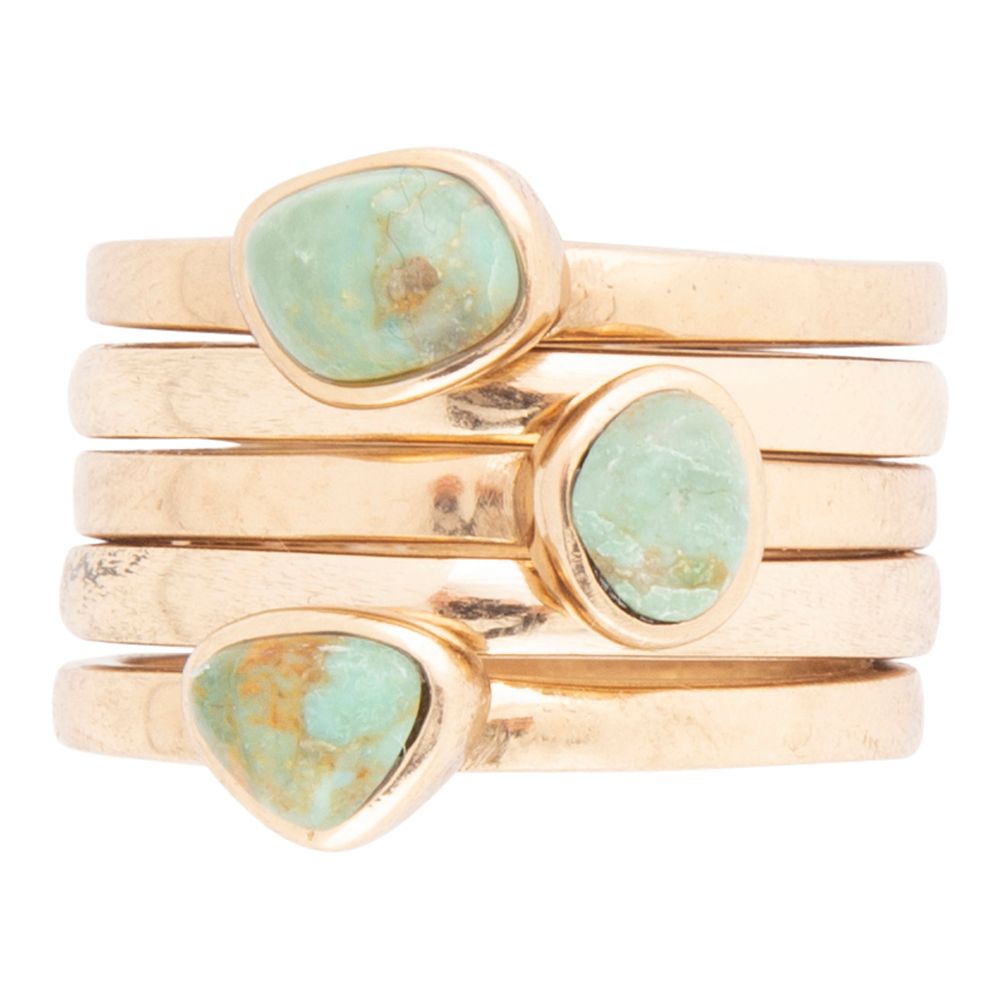 Set of blue turquoise and golden stacking rings by Barse Jewelry featuring multiple stylish rings for layered jewelry looks.