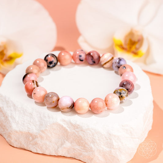Peruvian Pink Opal bracelet from Conscious Items featuring polished pink gemstone beads on an elastic cord.